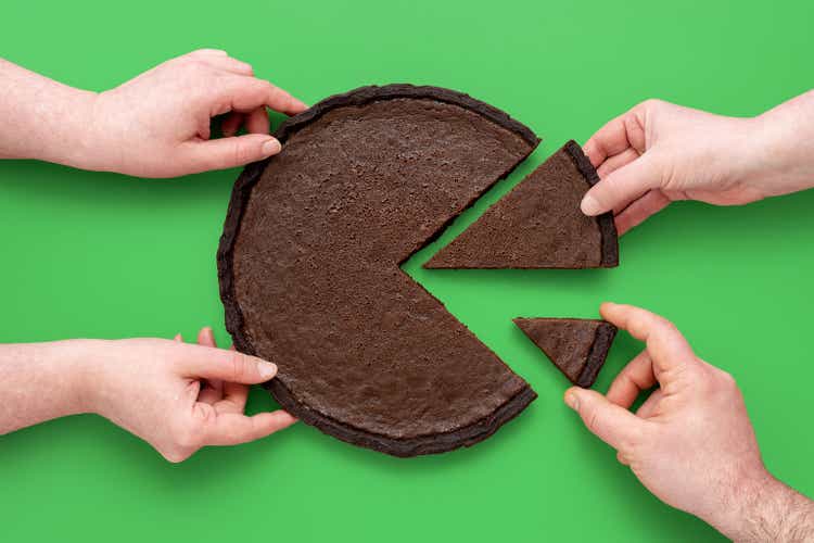 Pie chart concept, people sharing chocolate cake, above view on a green background.