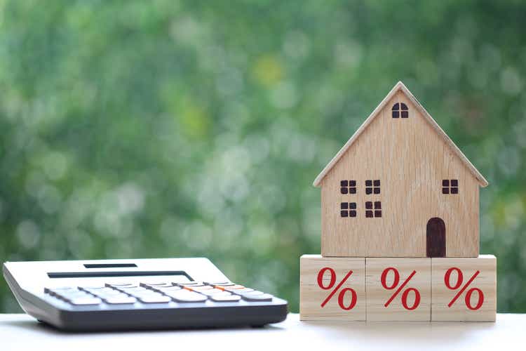 Estate tax,Model house with Percentage symbol icon on green background,Business investment and Property tax concept