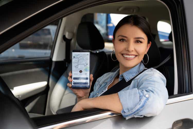 Happy crowdsourced taxi driver using a mobile app