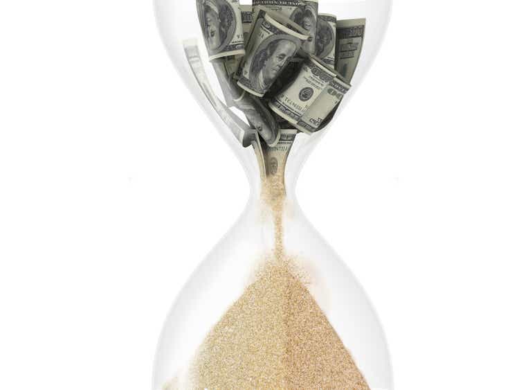 hourglass with dollar inside (time is money concept)