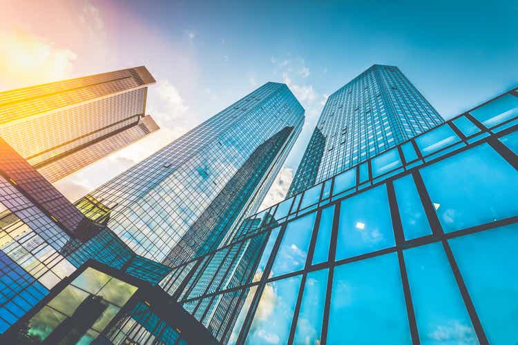 Modern skyscrapers in business district at sunset with lens flare effect