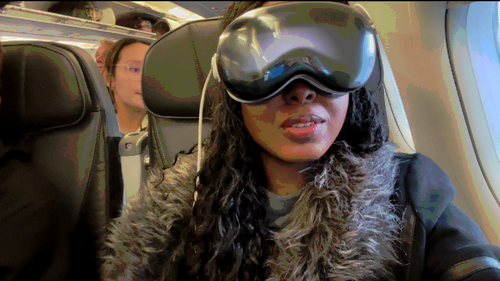 Woman wearing Apple Vision Pro on a plane