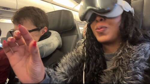 Woman with Apple Vision Pro on plane