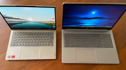 a top down view of an open lenovo thinkbook and an open hp chromebook plus on a wood table