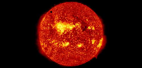 Venus visible as a tiny dot on the sun during the planet's transit.