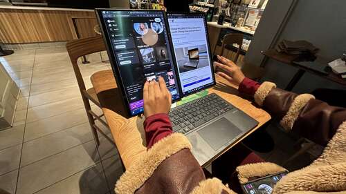 Asus Zenbook Duo juggling two apps with woman's fingers interacting with it