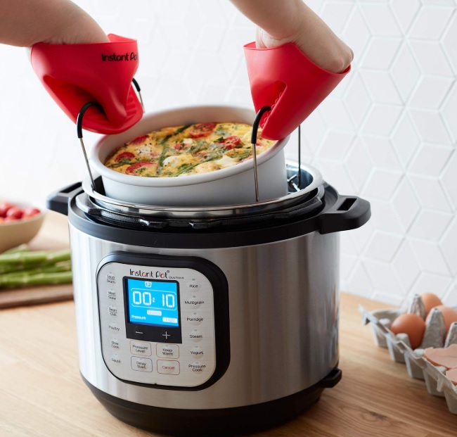 Removing a bowl from the Instant Pot. 