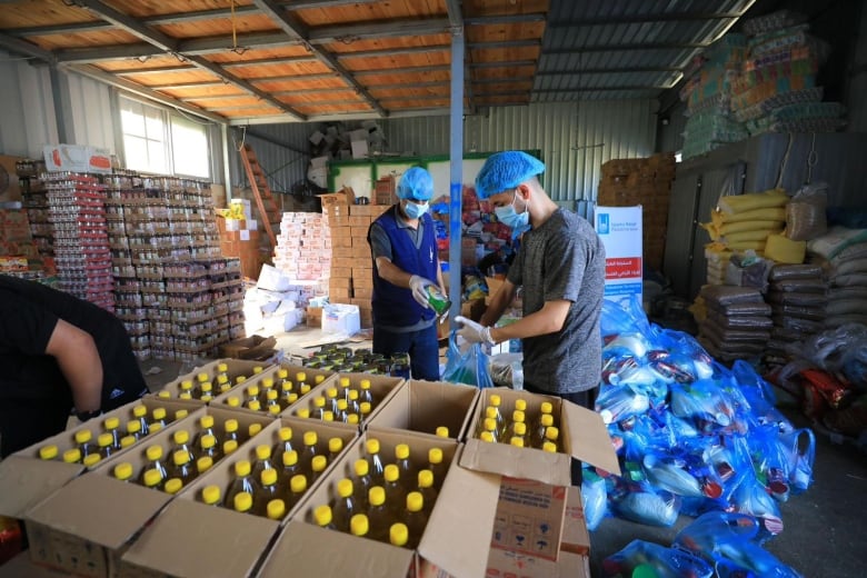 Staff and volunteers with Islamic Relief distributing food items in Gaza.