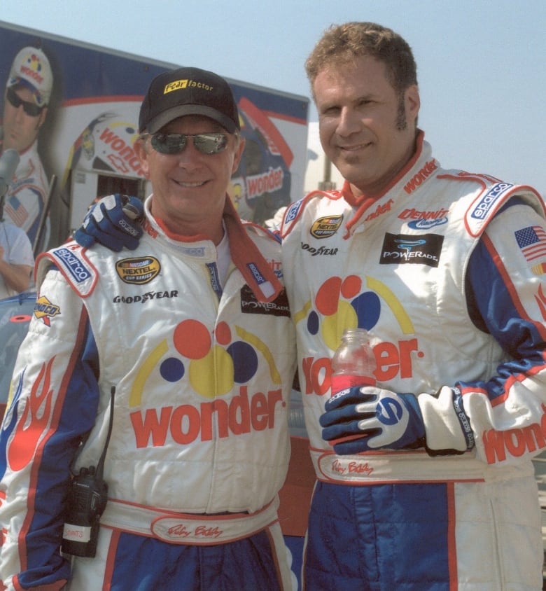 Jack Gill and Will Ferrell wear identical racing uniforms.