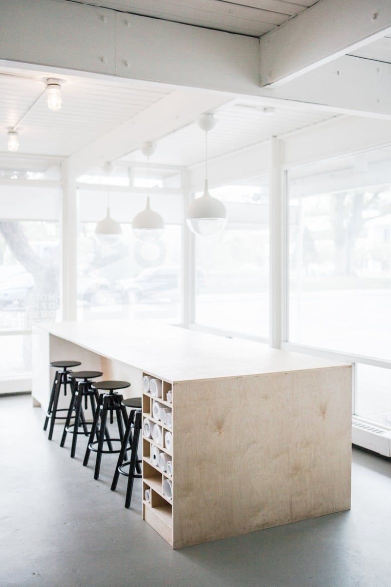 A large wooden table sits in an office.