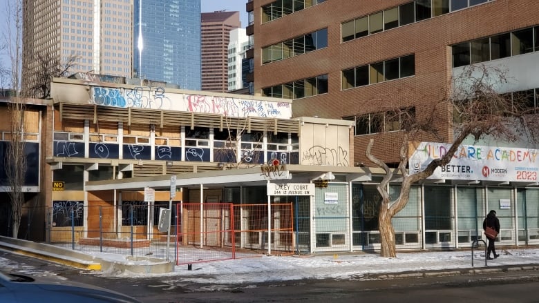 A derelict office building seen from across a city street.