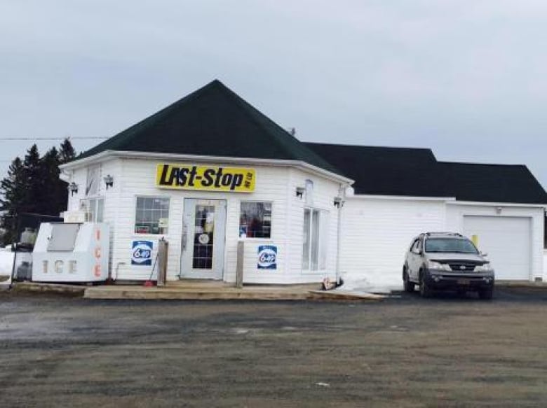 A Convenience store with a car parked outside. 