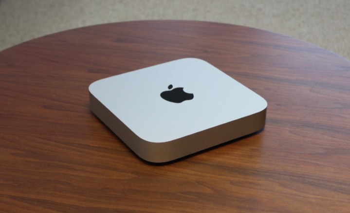 The Mac mini on a wooden table.