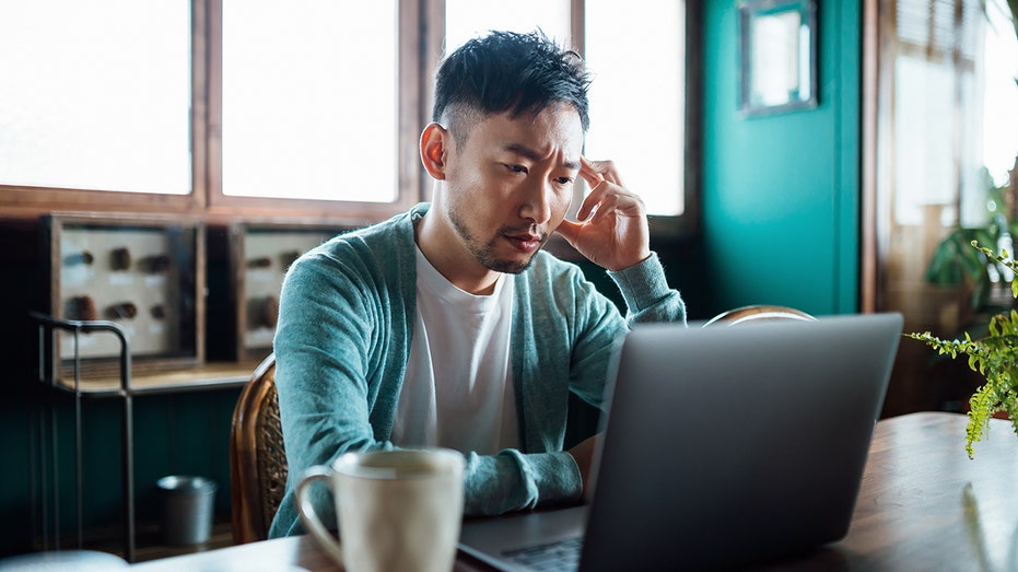 A man works from home on his laptop.