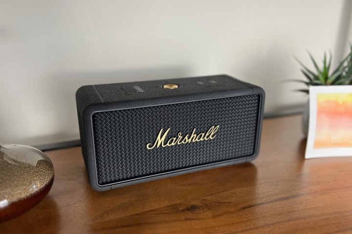 The Marshall Middleton Bluetooth speaker on a bookshelf.