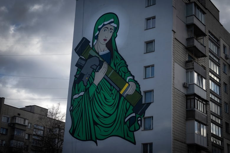 A mural shows a fictional character known as 'Saint Javelin' on the side of an apartment building in Kyiv.