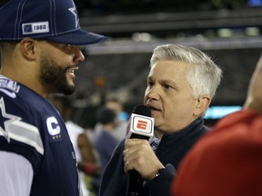 ESPN reporter Chris Mortensen, right, interviews Dallas Cowboys quarterback Dak Prescott, left, after an NFL football game against the New York Giants, Nov. 5, 2019, in East Rutherford, N.J.