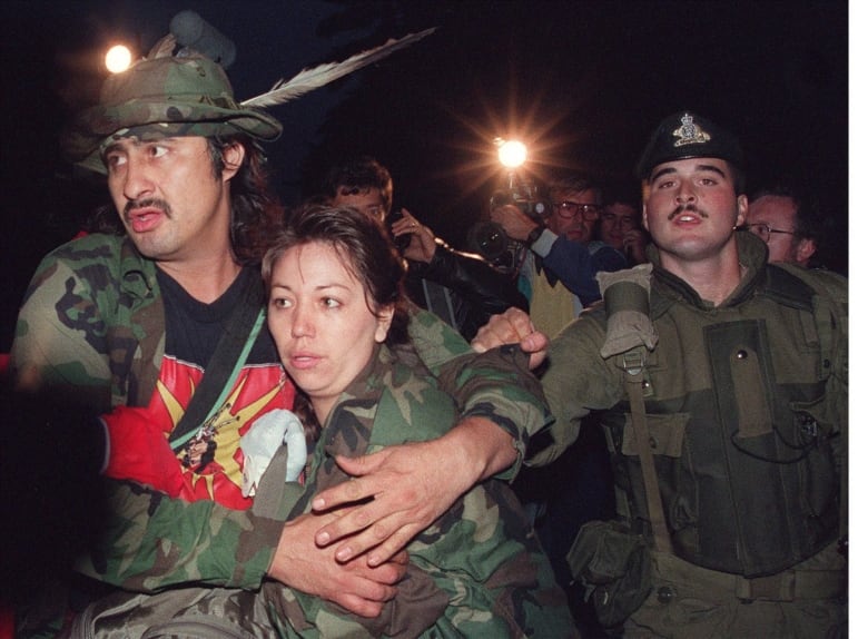 Soldiers arrest an Indigenous Canadian during the Oka Crisis. 