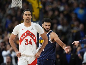 Toronto Raptors centre Jontay Porter (34) and Denver Nuggets guard Jamal Murray (27) in the second half of an NBA basketball game Monday, March 11, 2024, in Denver.