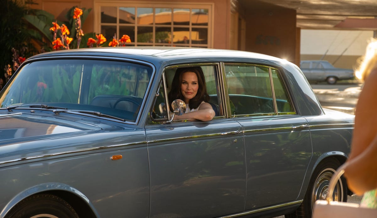 woman drives classic blue car