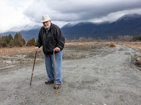 Robert Spiller in front of soil that's been dumped on farmland in Hatzic.