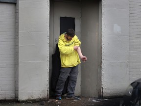 A man uses drugs on Dunlevy Avenue in Vancouver.