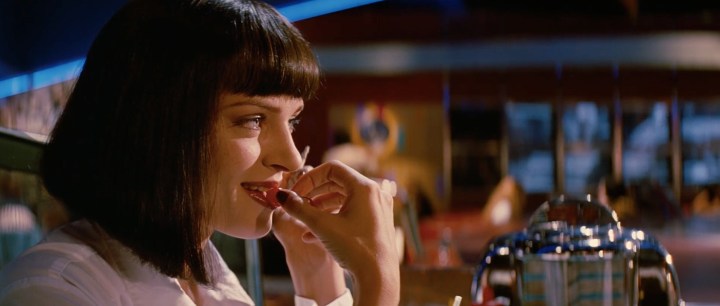 A woman licks her lips in Pulp Fiction.