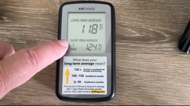 Picture of a radon monitor. The reading is 118 Bq/m3 which is a normal level of gas.