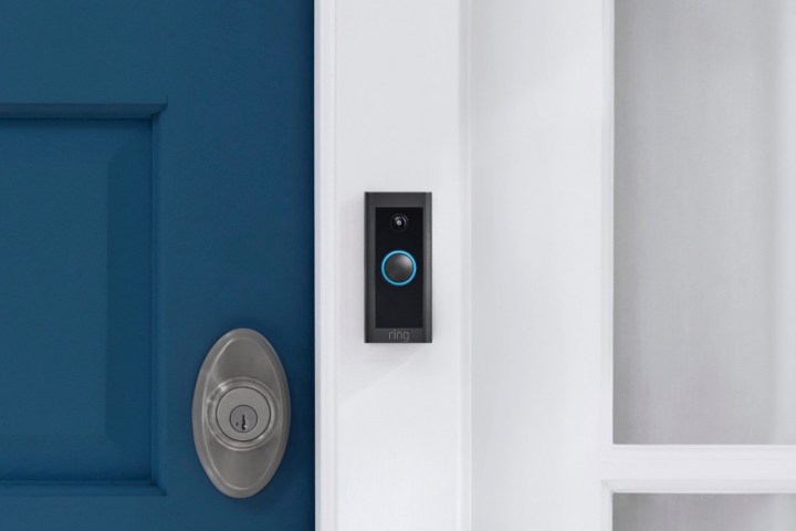 Ring Video Doorbell Wired perched on front door.