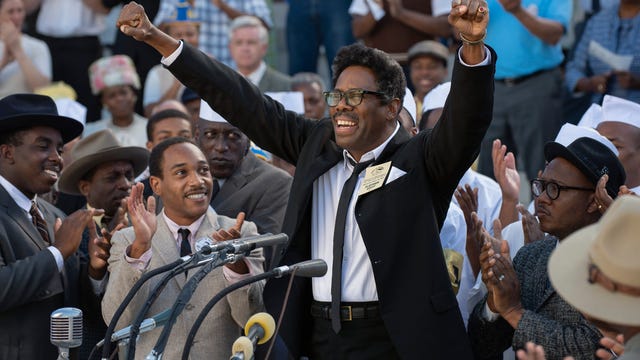 Colman Domingo as Bayard Rustin standing on a podium in front of a huge crowd