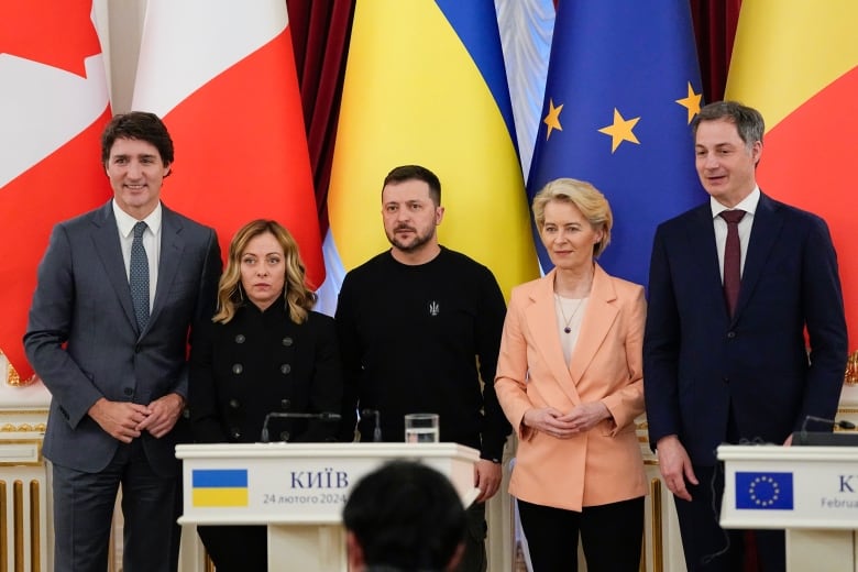 A group of world leaders pose for a photo.