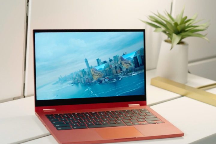 A red Samsung Galaxy Chromebook opened on a table.