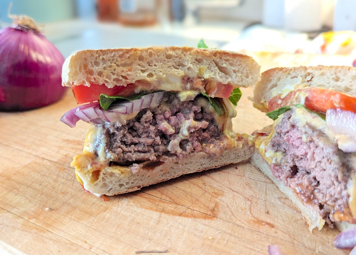 a burger cooked to medium cut in half