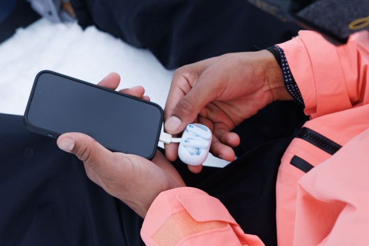 SkullCandy EcoBuds connected to a phone.