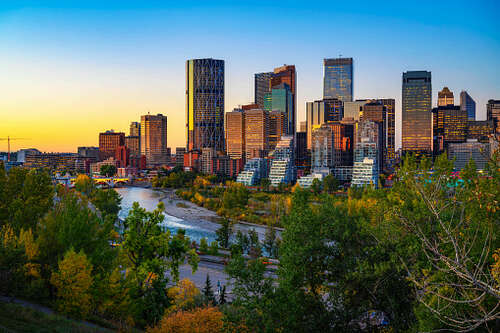 Sunset above city skyline of Calgary with Bow River, Canada