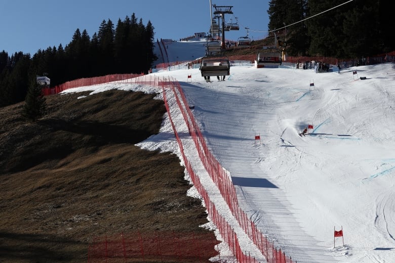 An athlete speeds down a ski course