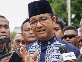 FILE - Presidential candidate Anies Baswedan talks to media after Friday prayer at a mosque in Jakarta, Indonesia, Friday, Feb. 16, 2024. Baswedan, a runner-up in Indonesia's presidential election filed a complaint with the Constitutional Court on Thursday, March 21, alleging widespread irregularities and fraud at the polls.