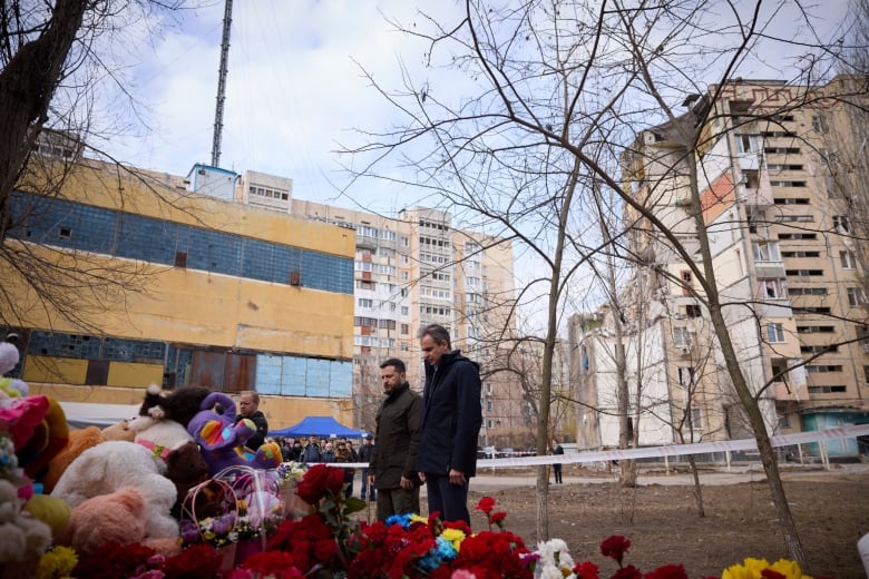 Ukrainian President Volodymyr Zelenskyy and Greek Prime Minister Kyriakos Mitsotakis lay flowers at site of a Russian drone attack on a residential area of Odesa, Ukraine.