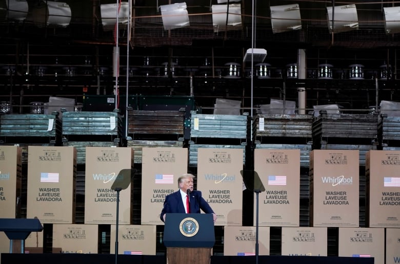 trump in front of boxes