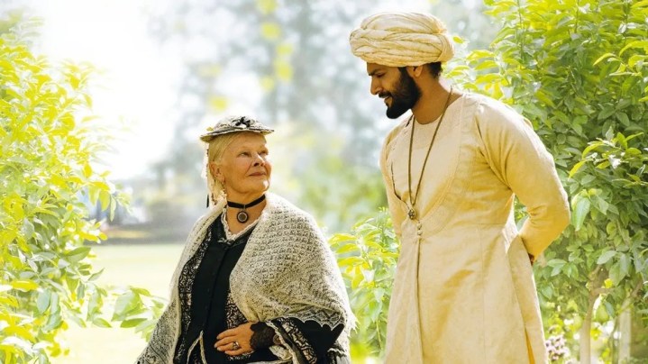 An older woman and a man look at each other in Victoria & Abdul.