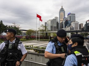 Police officers stand guard outside the Legislative Council in Hong Kong, Tuesday, March 19, 2024. Hong Kong's lawmakers met in a special session to resume debate on a proposed national security law Tuesday, paving the way to grant the government more power to quash dissent in the southern Chinese city.