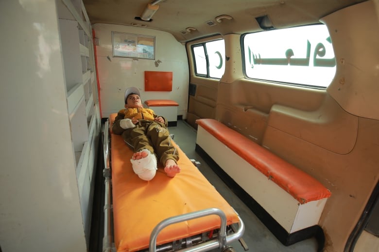 Yahad Hamad on a stretcher in the ambulance that is taking him out of Gaza,  to Egypt.