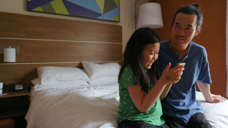 Yan Liu and his daughter, Emma, Facetime with his wife in China.