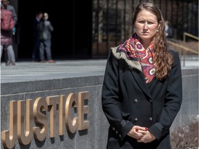 Anastasia Boldireff stands outside the sign on the Montreal courthouse