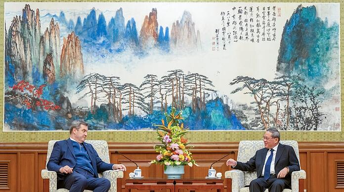 27.03.2024, China, Peking: Markus Söder, (l, CSU) Ministerpräsident von Bayern, wird in Peking von LI Qiang (r), Premierminister der Volksrepublik China, empfangen. Söder bereist bis zum 28.03.2024 die Volksrepublik China. (zu dpa: «Söder hofft nach Treffen mit Li Qiang auf Abbau von Handelsschranken») Foto: Peter Kneffel/dpa +++ dpa-Bildfunk +++