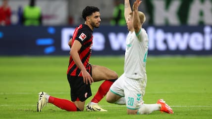 FRANKFURT AM MAIN, GERMANY - APRIL 05: Omar Marmoush of Eintracht Frankfurt looks on as Romano Schmid of SV Werder Bremen reacts during the Bundesliga match between Eintracht Frankfurt and SV Werder Bremen at Deutsche Bank Park on April 05, 2024 in Frankfurt am Main, Germany. (Photo by Alexander Hassenstein/Getty Images)