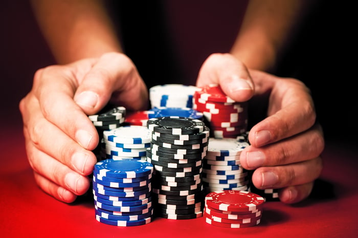 Sliding poker chips across the table.