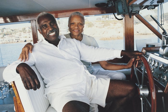 Two smiling people on a boat.