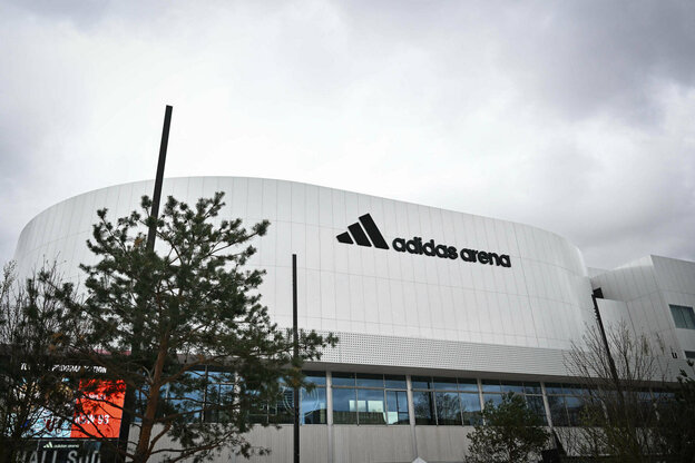 Die weiße Adidas Arena im Norden von Paris, an der Menschen ohne Papiere mitgearbeitet haben, erstreckt sich entgegen den grauen Himmel.