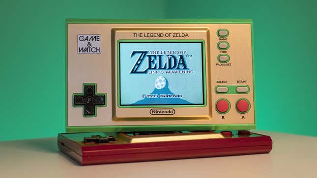 The Nintendo Game & Watch The Legend of Zelda, with The Legend of Zelda Link's Awakening on screen, photographed against a green background.